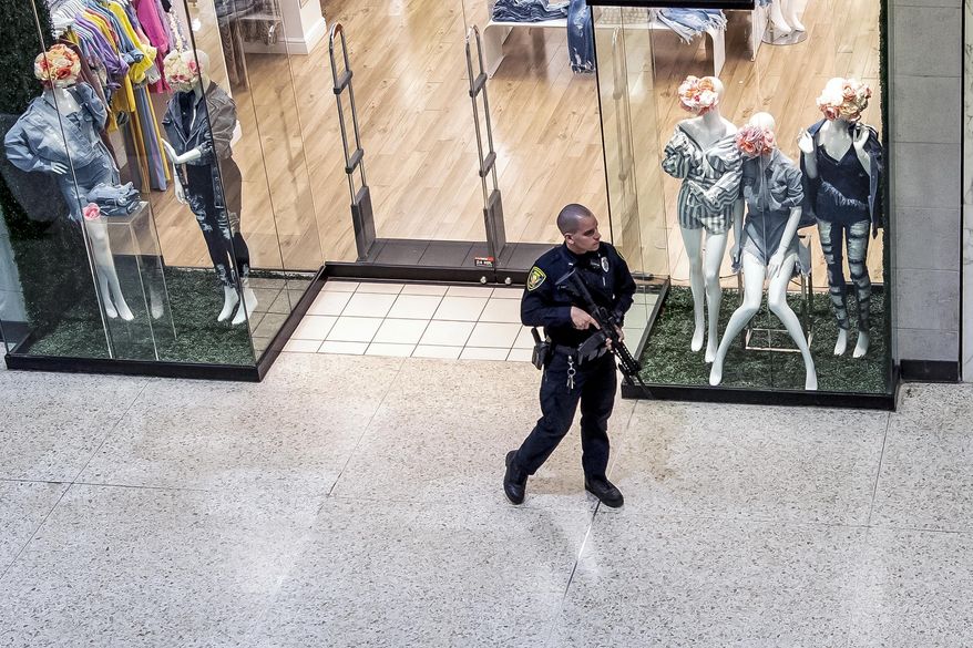 Responding to a call of shots fired, a Monroeville Police officer patrols the Monroeville Mall, Friday, April 12, 2019, in Monroeville, Pa. (Alexandra Wimley/Pittsburgh Post-Gazette via AP)