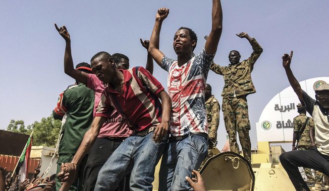 Sudanese celebrate after officials said the military had forced longtime autocratic President Omar al-Bashir to step down after 30 years in power in Khartoum, Sudan, Thursday, April 11, 2019. (AP Photo)
