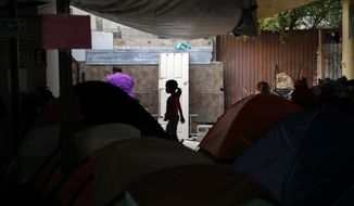 A girl from the Mexican state of Guerrero passes rows of tents as her family waits at a shelter of mostly Mexican and Central American migrants to begin the process of applying for asylum Friday, April 12, 2019, in Tijuana, Mexico. The Trump administration is asking an appeals court to let it continue returning asylum seekers to Mexico hours before a U.S. judge&#39;s order was set to go into effect Friday afternoon reversing the unprecedented change to the U.S. asylum process. (AP Photo/Gregory Bull)