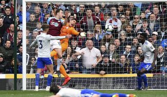Cardiff City goalkeeper Neil Etheridge drops the ball under pressure from Burnley&#x27;s Ashley Barnes during the English Premier League soccer match between Burnley and Cardiff Ciry at Turf Moor, IN Burnley, England, Saturday, April 13, 2019. (Anthony Devlin/PA via AP)