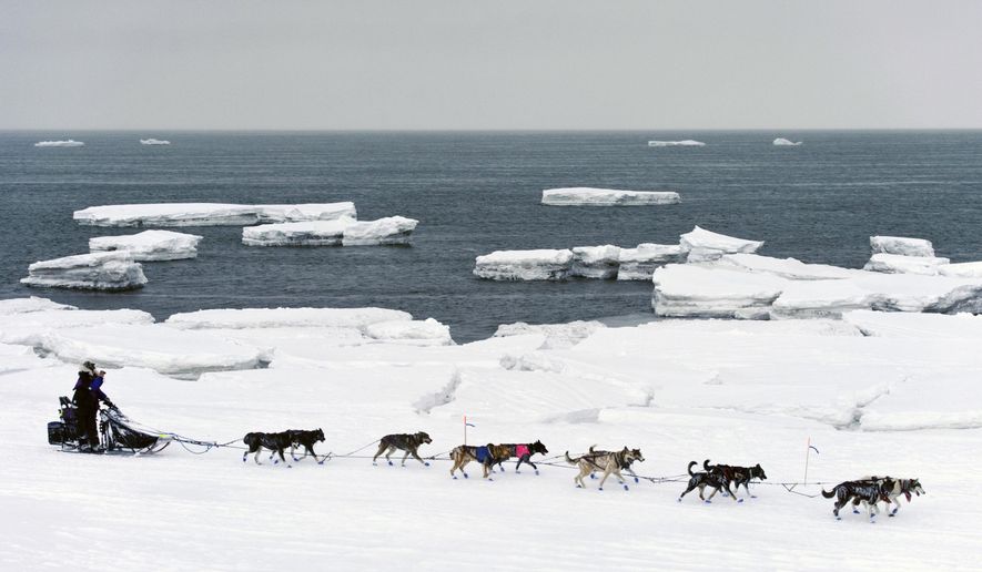 FILE - In this March 13, 2019, file photo, Jessie Royer passes icebergs in open water on Norton Sound as she approaches Nome, Alaska, in the Iditarod trail sled dog race. When a Feb. 22 storm pounded Norton Sound, water surged up the Yukon River and into Kotlik, flooding low-lying homes. The Bering Sea last winter saw record-low sea ice. Climate models predicted less ice, but not this soon, said Seth Danielson, a physical oceanographer at the University of Alaska Fairbanks. (Marc Lester/Anchorage Daily News via AP, File)