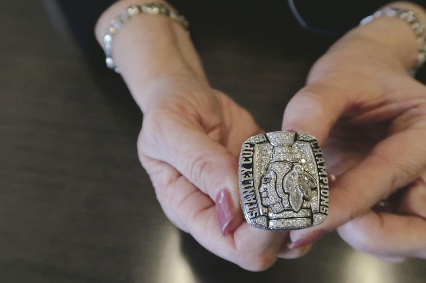 In this March 3, 2019 photo, Julie Kavanaugh, formerly an administrator with the Chicago Blackhawks, holds her Stanley Cup ring in Ashland, Ky. Kavanaugh received the ring during her time with NHL hockey club. She is now an employee of Braidy Industries. (Glenn Puit/The Daily Independent via AP)
