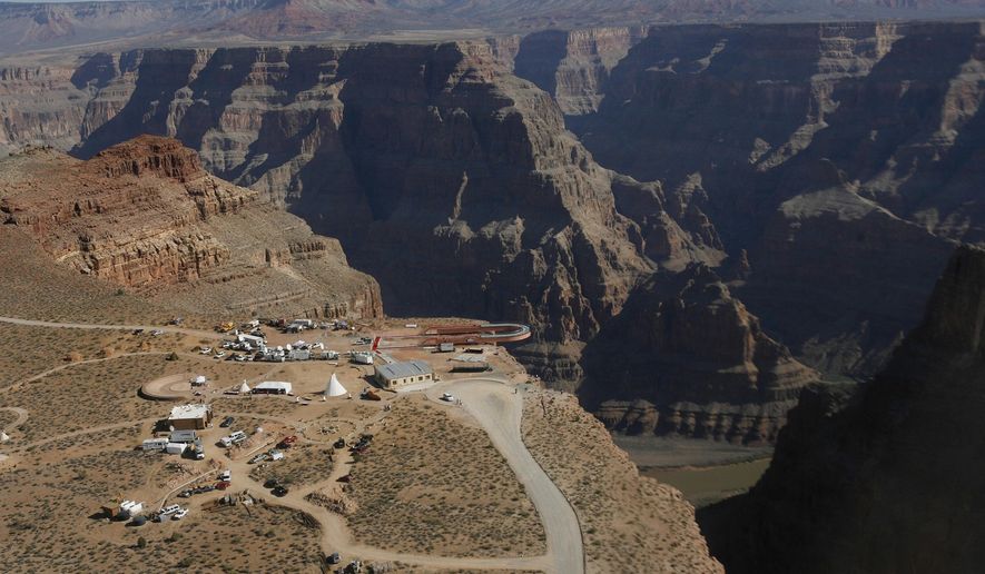 FILE - In this March 20, 2007, file photo, the Skywalk hangs over the Grand Canyon on the Hualapai Indian Reservation before its grand opening ceremony at Grand Canyon West, Ariz. Two recent deaths in which men plummeted to their death in the Grand Canyon follow dozens of apparently accidental fatal falls since the national park was established 100 years ago. (AP Photo/Ross D. Franklin, File)
