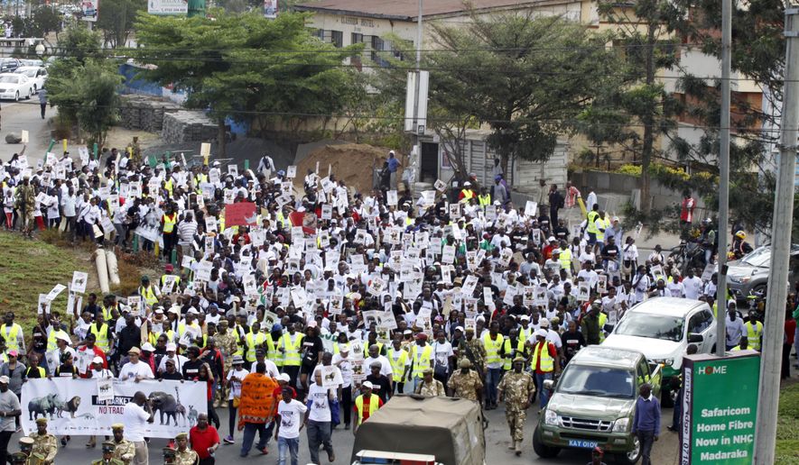 Demonstrators walk through the streets of Nairobi, in Kenya Saturday, April 13, 2019. Demonstrators walked through the streets of Nairobi to participate in a Global March to support wildlife Elephants and Rhinos. Kenya is a leading wildlife safari destination that has been grappling with declining wildlife numbers.(AP Photo/Khalil Senosi)