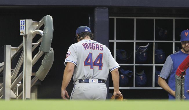 New York Mets pitcher Jason Vargas enter the dugout after pulled from the team's baseball game against the Atlanta Braves during the first inning Saturday, April 13, 2019, in Atlanta. (AP Photo/Tami Chappell)