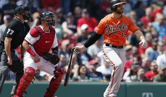 Baltimore Orioles&#39; Chris Davis watches his two-run single in front of Boston Red Sox&#39;s Christian Vazquez during the first inning of a baseball game in Boston, Saturday, April 13, 2019. (AP Photo/Michael Dwyer)