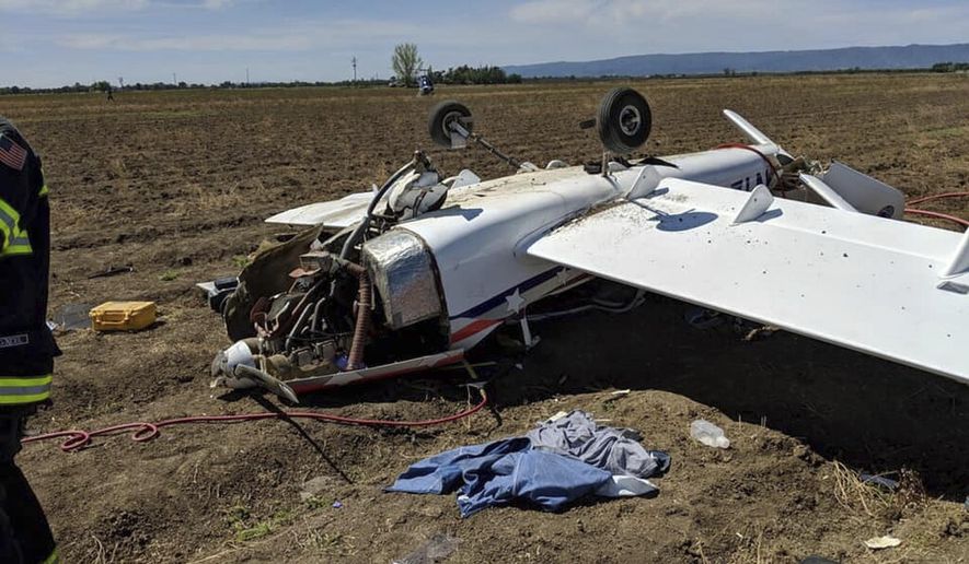 In this photo provided by the Yolo County Sheriff's office, Yolo County Sheriff's deputies respond to a small plane crash a little after 11 a.m. Saturday, April 13, 2019, near Yolo County Airport in Davis, Calif. The Yolo County Sheriff's office said the sole occupant was taken to a hospital. Davis is home to the University of California, Davis. KCRA-TV reports the plane took off from the Yolo County Airport and landed upside down in a farm field. (Yolo County Sheriff's Office via AP)