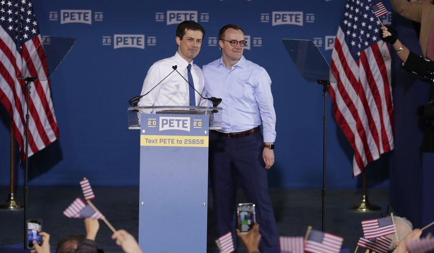 Pete Buttigieg is joined by his husband Chasten Glezman before he announced that he will seek the Democratic presidential nomination during a rally in South Bend, Ind., Sunday, April 14, 2019. Buttigieg, 37, is serving his second term as the mayor of South Bend. (AP Photo/Michael Conroy)