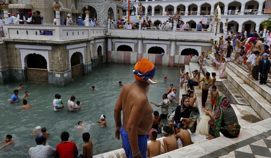 A Sikh pilgrim leaves after taking a holy bath during the Vasakhi festival, at the shrine of Gurdwara Punja Sahib, the second most sacred place for Sikhs, in Hasan Abdal, some 50 kilometers (31 Miles) from Islamabad, Pakistan, Sunday, April 14, 2019. Thousands of Sikh pilgrims arrived from neighboring India and other countries to attend the harvest festival that is regionally known by many names and marks the Solar New Year. (AP Photo/Anjum Naveed)
