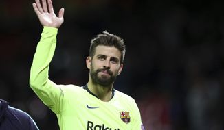 Barcelona&#39;s Gerard Pique waves to the fans after the Champions League quarterfinal, first leg, soccer match between Manchester United and FC Barcelona at Old Trafford stadium in Manchester, England, Wednesday, April 10, 2019. Barcelona won 1-0. (AP Photo/Jon Super)