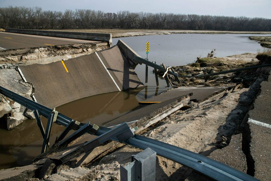 A bridge destroyed by floodwaters on Highway 39 is shown Friday, April 5, 2019, near Silver Creek, Neb. The damage is preventing students from reaching Silver Creek High School. (Brendan Sullivan/Omaha World-Herald via AP)