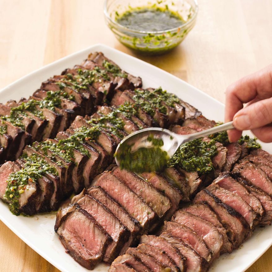 This undated photo provided by America's Test Kitchen in April 2019 shows Argentine Steaks with Chimichurri Sauce in Brookline, Mass. This recipe appears in the cookbook "Vegetables Illustrated." (Carl Tremblay/America's Test Kitchen via AP)