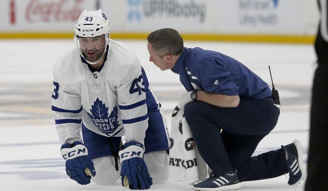 Toronto Maple Leafs center Nazem Kadri (43) looks up from the ice as he is attended to by a trainer after taking a hit during the second period of Game 2 of an NHL hockey first-round playoff series against the Boston Bruins, Saturday, April 13, 2019, in Boston. (AP Photo/Mary Schwalm)