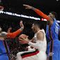 Portland Trail Blazers center Enes Kanter, center, grabs a rebound as Oklahoma City Thunder center Steven Adams, front left, and Thunder forward Paul George, right, defend during the second half of Game 1 of a first-round NBA basketball playoff series in Portland, Ore., Sunday, April 14, 2019. (AP Photo/Steve Dipaola)