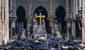 Debris are seen inside Notre Dame cathedral in Paris, Tuesday, April 16, 2019. Firefighters declared success Tuesday in a more than 12-hour battle to extinguish an inferno engulfing Paris&#39; iconic Notre Dame cathedral that claimed its spire and roof, but spared its bell towers and the purported Crown of Christ. (Christophe Petit Tesson, Pool via AP)