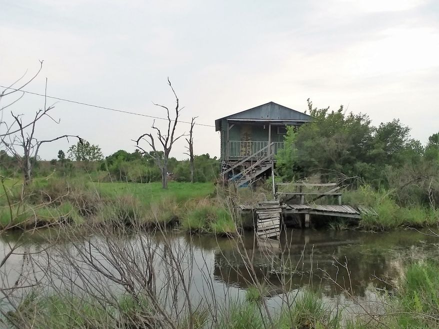 Camps and homes on Isle de Jean Charles, Louisiana. A &quot;camp&quot; is what they call a place where you go for fishing and/or hunting. It&#39;s usually just a place where guys will spend a weekend, so they don&#39;t care if there&#39;s running water or electricity. (James Varney — The Washington Times)