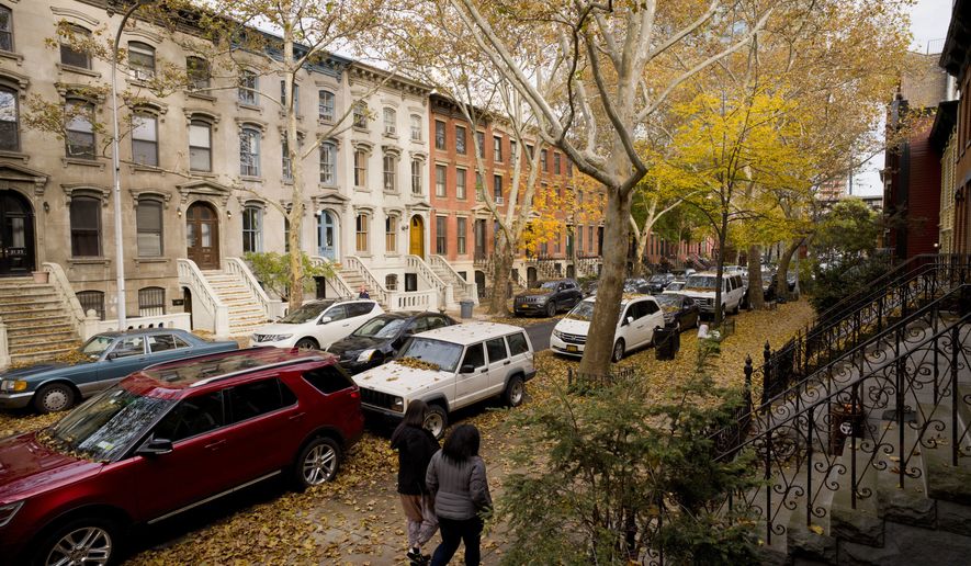 FILE - In this Nov. 7, 2018, file photo, fallen leaves cover cars and sidewalks on a tree-lined residential block in Long Island City in the Queens borough of New York. How your parents prepare for retirement, long-term care and estate planning can affect your own financial future. Talking to them now can save your family headaches and messy conversations down the road. (AP Photo/Mark Lennihan, File)
