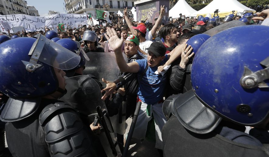 Students carry banners and chant slogans during a demonstration in Algiers, Algeria, Tuesday, April 16, 2019. President of the Algerian Constitutional Council Tayeb Belaiz resigned on Tuesday amid mass protests in the country demanding for his departure. "Belaiz notified the members of the Constitutional Council, during a meeting held Tuesday, that he presented his resignation to the interim president Abdelkader Bensalah," the council said in a statement. (AP Photo/Toufik Doudou)