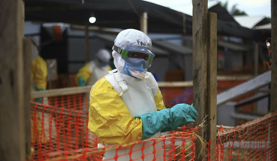 An Ebola health worker is seen at a treatment center in Beni, Eastern Congo, Tuesday April, 16, 2019. Congo&#x27;s president on Tuesday said he wants to see a deadly Ebola virus outbreak contained in less than three months even as some health experts say it could take twice as long. (AP Photo/Al-hadji Kudra Maliro)