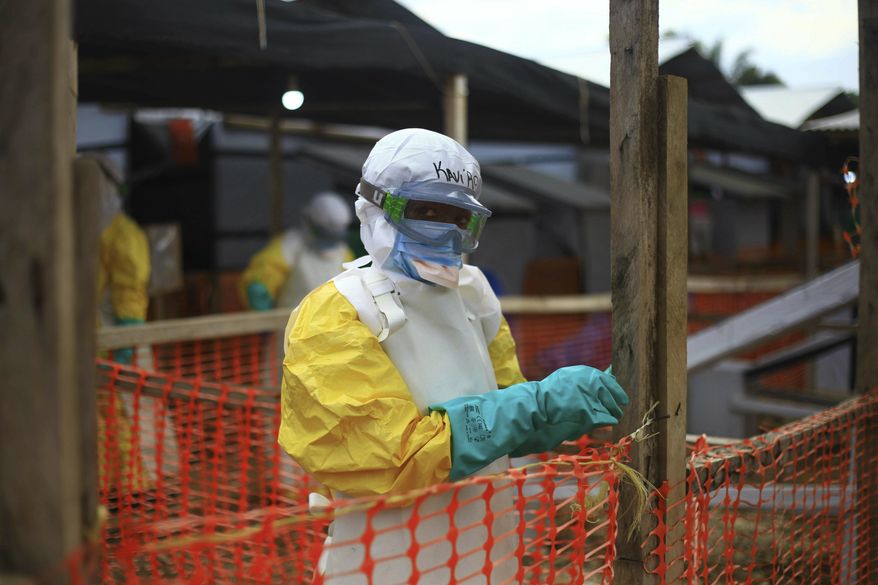 An Ebola health worker is seen at a treatment center in Beni, Eastern Congo, Tuesday April, 16, 2019. Congo's president on Tuesday said he wants to see a deadly Ebola virus outbreak contained in less than three months even as some health experts say it could take twice as long. (AP Photo/Al-hadji Kudra Maliro)