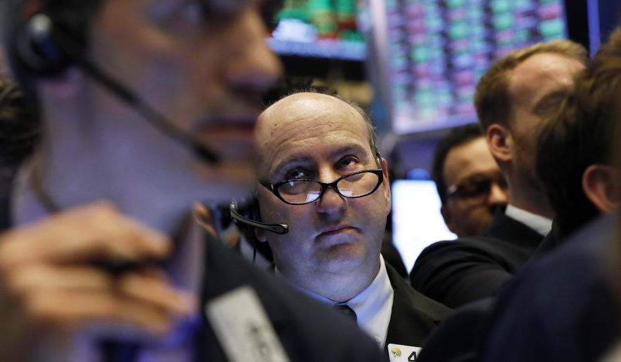 FILE - In this April 12, 2019, file photo trader Andrew Silverman, center, works on the floor of the New York Stock Exchange. The U.S. stock market opens at 9:30 a.m. EDT on Tuesday April 16. (AP Photo/Richard Drew, File)