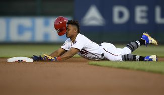 Washington Nationals&#39; Wilmer Difo slides into second with a double during the second inning of the team&#39;s baseball game against the San Francisco Giants, Tuesday, April 16, 2019, in Washington. (AP Photo/Nick Wass)