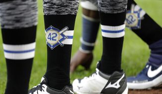 Seattle Mariners players wear No. 42 on their socks in honor of Jackie Robinson Day before a baseball game against the Cleveland Indians, Monday, April 15, 2019, in Seattle. (AP Photo/Ted S. Warren)