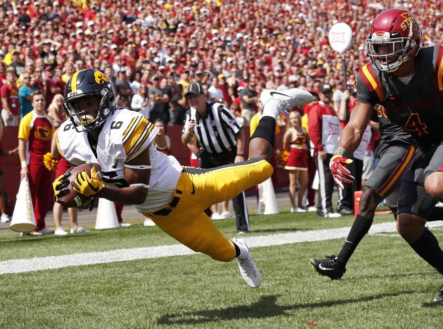 FILE - In this Sept. 9, 2017, file photo, Iowa wide receiver Ihmir Smith-Marsette (6) catches a 15-yard touchdown pass ahead of Iowa State defensive back Evrett Edwards, right, during the second half of an NCAA college football game, in Ames, Iowa. Iowa knows it’ll have to revamp its tight-end focused offense in 2019 after losing two of the best in school history to the NFL. Brandon Smith and Imhir Smith-Marsette will likely be the major benefactors of T.J. Hockenson and Noah Fant’s departures. (AP Photo/Charlie Neibergall, File)