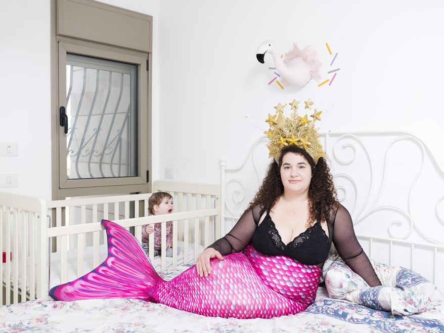 In this Friday, Feb. 22, 2019 photo, Hadas Kellner, a member of the Israeli Mermaid Community, poses for a portrait as she wears a mermaid tail at her home in Yahud, Israel. (AP Photo/Oded Balilty)