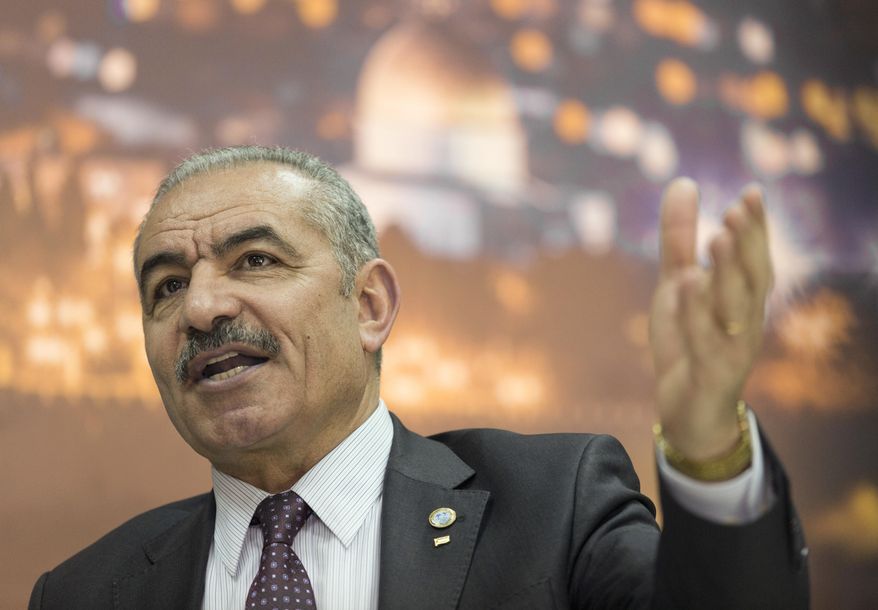 Palestinian Prime Minister Mohammad Shtayyeh italks during an interview with The Associated Press, at his office in the West Bank city of Ramallah, Tuesday, April 16, 2019. (AP Photo/Nasser Nasser)
