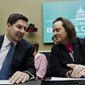 FILE - In this Feb. 13, 2019, file photo, Sprint Corp. Executive Chairman Marcelo Claure, left, speaks with T-Mobile U.S. CEO and President John Legere during the House Commerce subcommittee hearing on Capitol Hill in Washington. (AP Photo/Jose Luis Magana, File)