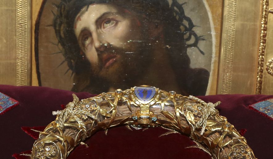 In this Friday, March 21, 2014, file photo a crown of thorns which was believed to have been worn by Jesus Christ and which was bought by King Louis IX in 1239 is presented at Notre Dame Cathedral in Paris. Paris&#39; mayor, Anne Hidalgo, said a significant collection of art and holy objects inside the church had been recovered from the fire at Notre Dame cathedral. In a tweet later, she thanked firefighters and others who formed a human chain to save artifacts. &quot;The crown of thorns, the tunic of St. Louis and many other major artifacts are now in a safe place,&quot; she wrote. (AP Photo/Remy de la Mauviniere, File)