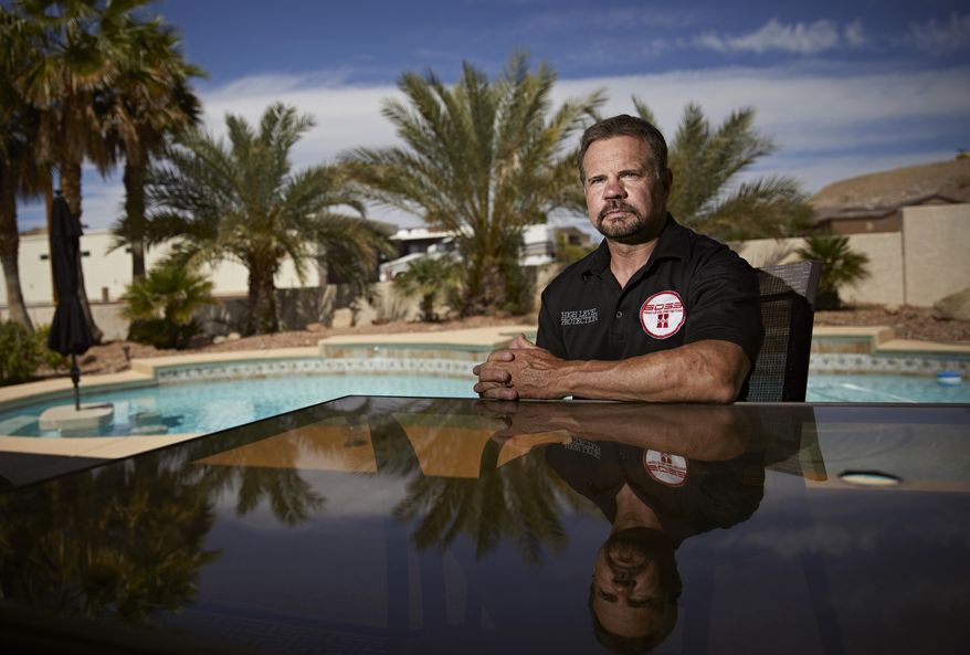 In this April 9, 2019, photo, Grant Whitus poses for a portrait at his home in Lake Havasu City, Ariz. Whitus&#39; marriage fell apart a year after he led his SWAT team into Columbine High School&#39;s library, where he was the first to find the dead children&#39;s bodies. (AP Photo/John Locher)