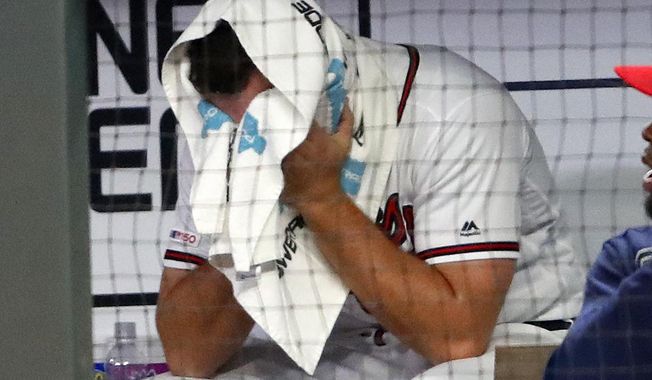 Atlanta Braves relief pitcher Jesse Biddle sits on the bench after walking in the go-ahead run in the 10th inning of the team&#x27;s baseball game against the Arizona Diamondbacks on Wednesday, April 17, 2019, in Atlanta. Arizona won 3-2. (AP Photo/John Bazemore)