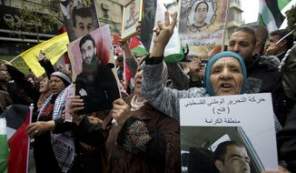 Relatives of Palestinians held in Israeli jails hold their portraits during a protest to mark &amp;quot;Prisoners Day&amp;quot; in the West Bank city of Ramallah, Wednesday, April 7, 2019.(AP Photo/Majdi Mohammed)