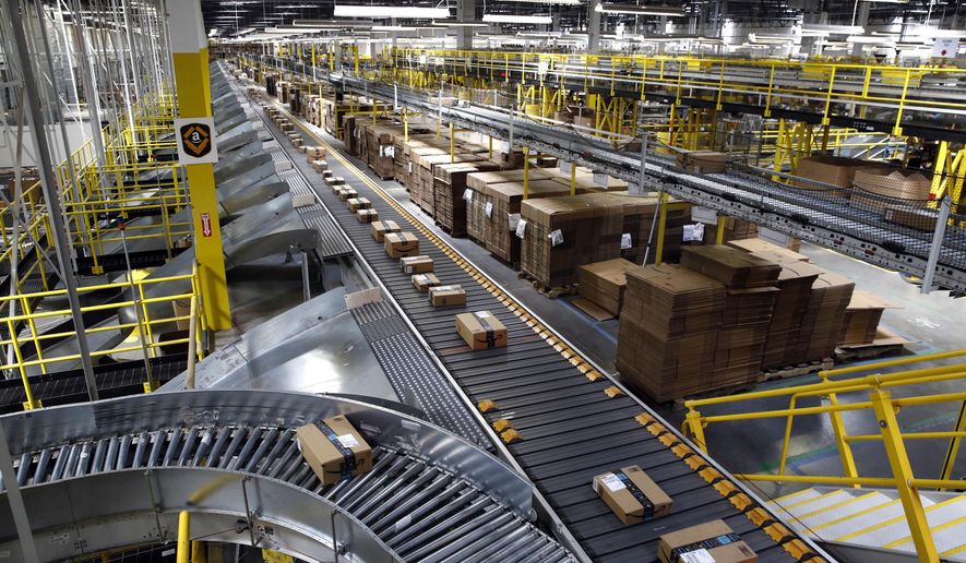 FILE- In this Aug. 3, 2017, file photo, packages ride on a conveyor system at an Amazon fulfillment center in Baltimore. Outside of ditching online shopping altogether, there are some small tweaks in how you shop that can cut down on the impact on the environment, such as slowing down shipping times and not filling up the cart with stuff you know you won’t keep. (AP Photo/Patrick Semansky, File)