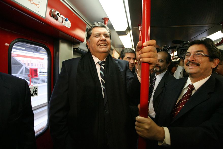In this July 11, 2011, file photo, Peru's outgoing President Alan Garcia, left, ride the soon to be inaugurated Line 1 electrical train system in Lima, Peru. A lawyer for the former Peruvian president said Wednesday, April 17, 2019, the leader shot himself before being detained by police amid allegations he received illegal payment from Brazilian construction giant Odebrecht. (AP Photo/Martin Mejia, File)