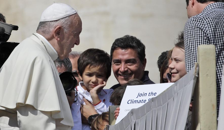 Pope Francis greets Swedish teenage environmental activist Greta Thunberg, right, during his weekly general audience in St. Peter&#39;s Square, at the Vatican, Wednesday, April 17, 2019. (AP Photo/Alessandra Tarantino)