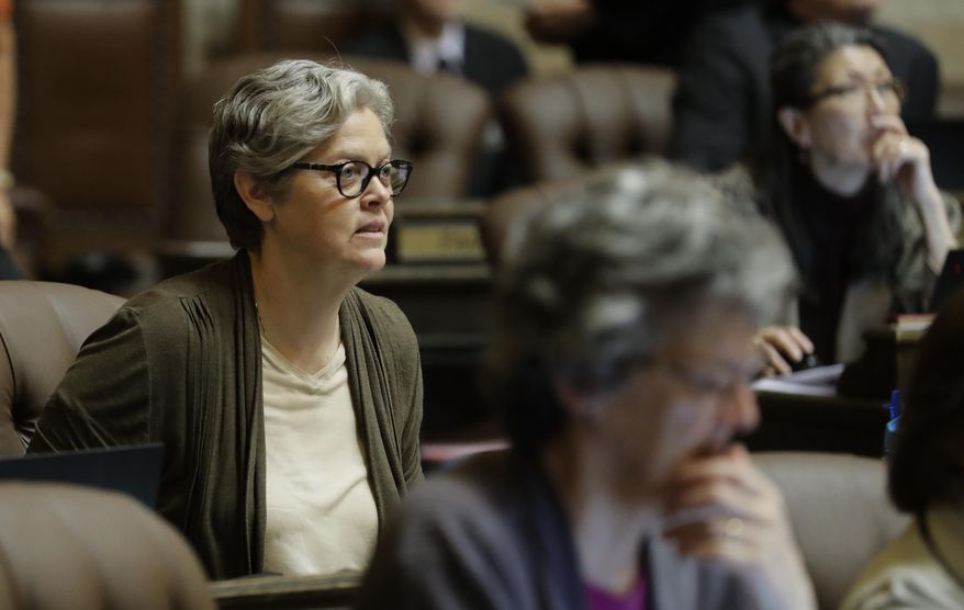 In this April 11, 2019 photo, Rep. Laurie Jinkins, D-Tacoma, listens to debate on the House floor at the Capitol in Olympia, Wash. Jinkins is the sponsor of a measure that has Washington poised to become the first state to establish an employee-paid program creating an insurance benefit to help offset the costs of long-term care, pending a final vote in the House. (AP Photo/Ted S. Warren)