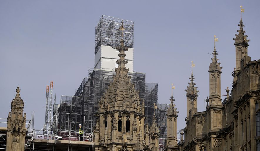 In this photo taken on Wednesday, April 17, 2019, Britain&#x27;s Houses of Parliament, covered in hoarding and scaffolding as it undergoes restoration work to repair the crumbling building, in London. For some Britons who watched Notre Dame in Paris burn, horror was mixed with apprehension. What happened to the French landmark this week could befall the Houses of Parliament tomorrow. The seat of Britain&#x27;s government is crumbling, leaky, infested with rodents, and a fire trap. (AP Photo/Kirsty Wigglesworth)