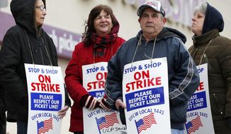 Striking workers stand on a picket line outside the Stop &amp;amp; Shop supermarket in Revere, Mass., Thursday, April 18, 2019. Some Jewish families in southern New England are preparing for Passover without the region&#x27;s largest supermarket chain. Thousands of workers remain on strike and rabbis in Massachusetts, Connecticut and Rhode Island are advising their congregations not to cross the picket lines. (AP Photo/Michael Dwyer)