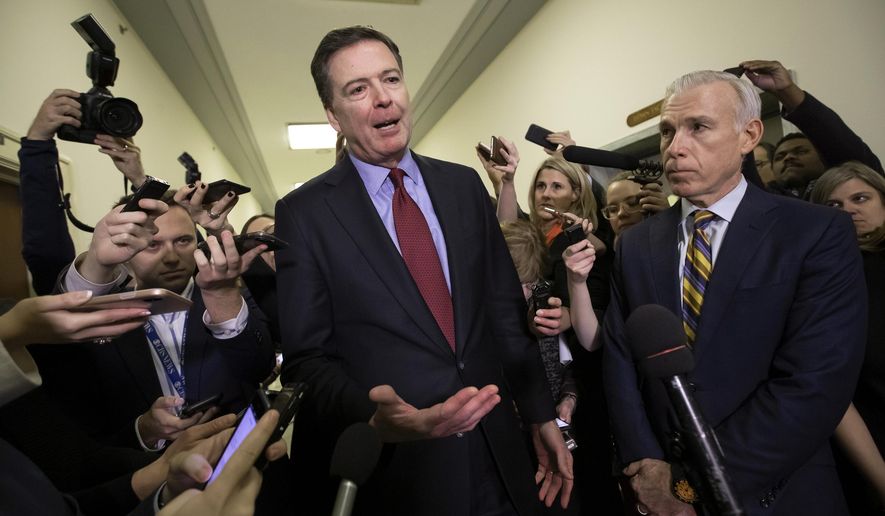 In this Dec. 7, 2018, file photo, Former FBI Director James Comey, with his attorney, David Kelley, right, speaks to reporters after a day of testimony before the House Judiciary and Oversight committees, on Capitol Hill in Washington. (AP Photo/J. Scott Applewhite, File)