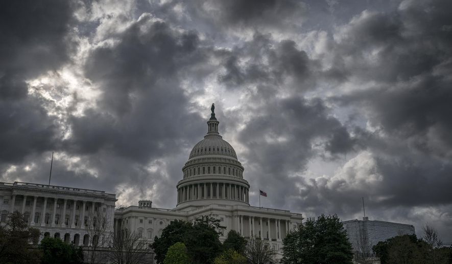 In this April 12, 2019, file photo morning clouds cover Capitol Hill in Washington. On Thursday, April 18, the Labor Department reports on the number of people who applied for unemployment benefits last week. (AP Photo/J. Scott Applewhite, File)