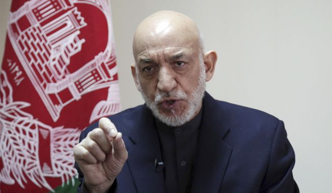 FILE - In this Feb. 16, 2019, file photo, former Afghan President Hamid Karzai speaks during an interview with The Associated Press in Kabul, Afghanistan. Karzai said Friday, April 19, 2019 that peace in his homeland, ravaged by more than 17 years of war, will not be possible until Afghans from all sectors of society sit together and negotiate _ including the Taliban.(AP Photo/Rahmat Gul, File)