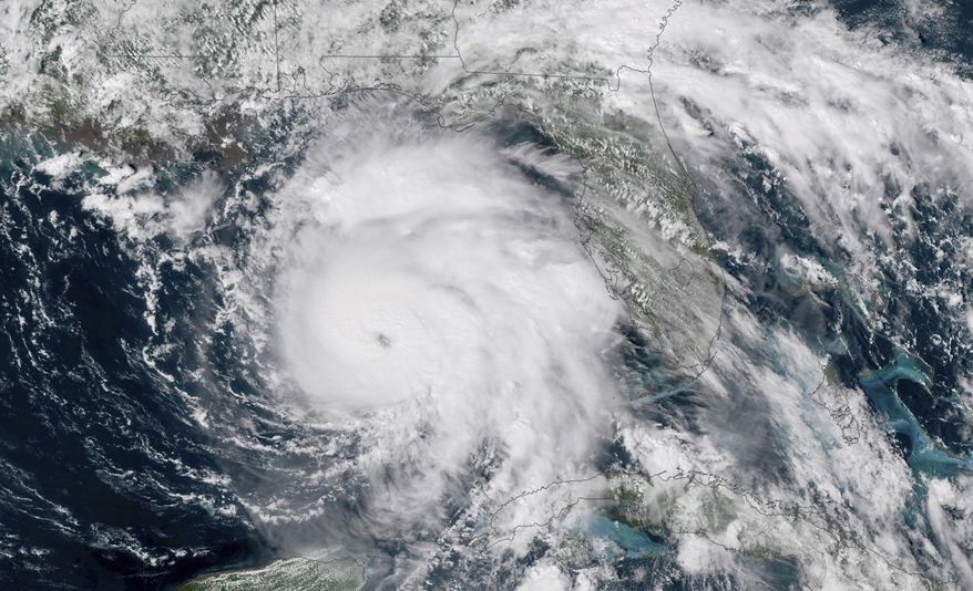 FILE-This Tuesday, Oct. 9, 2018 file satellite image provided by NOAA shows Hurricane Michael, center, in the Gulf of Mexico. Weather forecasters have posthumously upgraded last fall's Hurricane Michael from a Category 4 storm to a Category 5. The National Oceanic and Atmospheric Administration announced the storm's upgraded status Friday, making Michael only the fourth storm on record to have hit the U.S. as a Category 5 hurricane. (NOAA via AP)