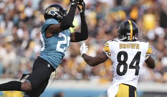 FILE - In this Nov. 18, 2018, file photo, Jacksonville Jaguars cornerback Jalen Ramsey, left, intercepts a pass in front of Pittsburgh Steelers wide receiver Antonio Brown (84) during the first half of an NFL football game in Jacksonville, Fla. Ramsey responded to Tom Coughlin’s public criticism Friday, April 19, saying the team knows why he’s skipping voluntary workouts. Ramsey did not elaborate on the reason for his absence in his Twitter post, but said he will be “ready when it’s time.” (AP Photo/Gary McCullough, File)