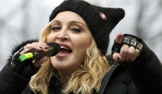 FILE - In this Jan. 21, 2017 file photo, Madonna performs on stage during the Women&#x27;s March rally in Washington.   Madonna and Colombian singer Maluma will bring their new collaboration to life when they perform at next month’s Billboard Music Awards.  NBC and dick clark productions announced Friday, April 19, 2019 that the duo will sing “Medellin” at the May 1 event in Las Vegas.  (AP Photo/Jose Luis Magana)