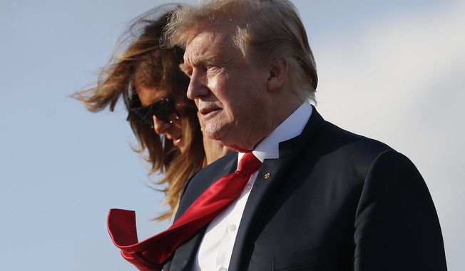 President Donald Trump and first lady Melania Trump, walk down the stairs of Air Force One during their arrival at Palm Beach International Airport, Thursday, April 18, 2019, in West Palm Beach, Fla. Trump traveled to Florida to spend the Easter weekend as his Mar-a-Lago estate. (AP Photo/Pablo Martinez Monsivais)