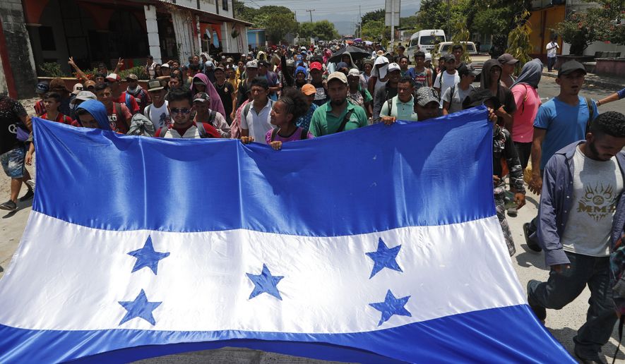 In this file photo, Honduras migrants, part of a caravan hoping to reach the U.S. border, carry their national flag as they arrive to Mapastepec, Chiapas State, Mexico, Saturday, April 20, 2019. In a letter to Secretary of State Mike Pompeo dated April 22, House Foreign Affairs Committee Chairman Eliot Engel, New York Democrat, and Texas Rep. Michael McCaul, the panel's ranking Republican, said the Trump adminstration's plan to cut financial aid to Central Ameican countries like Honduras "would be counterproductive and lead to increased migration flows to the U.S." (AP Photo/Moises Castillo) **FILE**