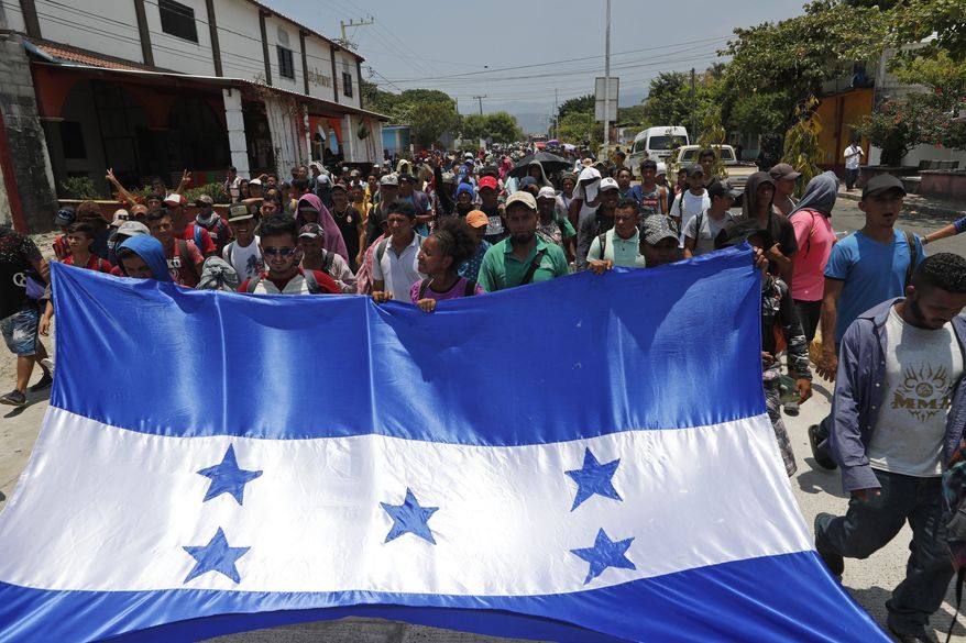 In this file photo, Honduras migrants, part of a caravan hoping to reach the U.S. border, carry their national flag as they arrive to Mapastepec, Chiapas State, Mexico, Saturday, April 20, 2019. In a letter to Secretary of State Mike Pompeo dated April 22, House Foreign Affairs Committee Chairman Eliot Engel, New York Democrat, and Texas Rep. Michael McCaul, the panel's ranking Republican, said the Trump adminstration's plan to cut financial aid to Central Ameican countries like Honduras "would be counterproductive and lead to increased migration flows to the U.S." (AP Photo/Moises Castillo) **FILE**